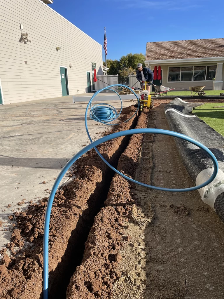 Element Mist Commercial Misting System solutions - showing a water line being installed in a trench