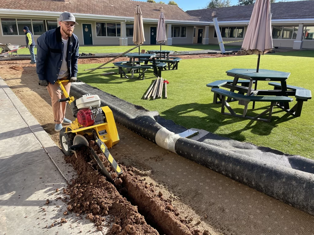 Element Mist Commercial Misting System solutions - showing a man digging a trench to run a water line